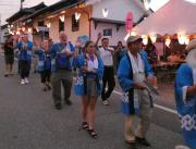 提灯の明かりがともされた会場に、青い法被を着たオレゴン市民の皆さんが、町民祭りに参加して踊りを踊っている様子の写真